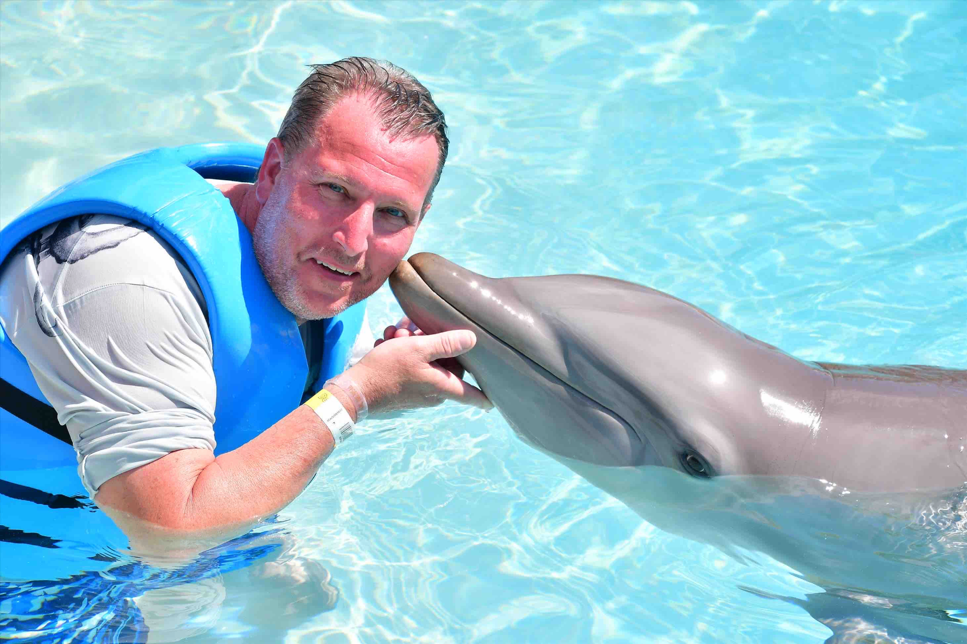 Mike swimming with a dolphin